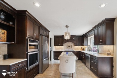 Discover luxurious lakefront living in this beautifully on Indianwood Golf and Country Club in Michigan - for sale on GolfHomes.com, golf home, golf lot