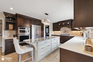 Discover luxurious lakefront living in this beautifully on Indianwood Golf and Country Club in Michigan - for sale on GolfHomes.com, golf home, golf lot