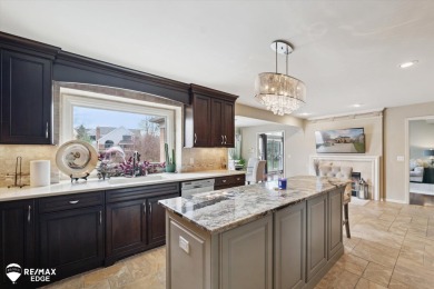 Discover luxurious lakefront living in this beautifully on Indianwood Golf and Country Club in Michigan - for sale on GolfHomes.com, golf home, golf lot