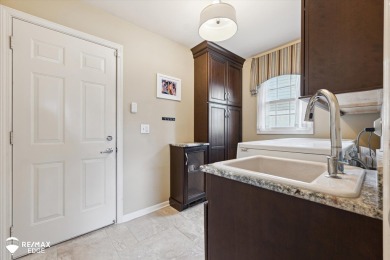 Discover luxurious lakefront living in this beautifully on Indianwood Golf and Country Club in Michigan - for sale on GolfHomes.com, golf home, golf lot