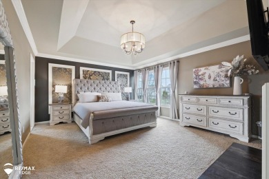 Discover luxurious lakefront living in this beautifully on Indianwood Golf and Country Club in Michigan - for sale on GolfHomes.com, golf home, golf lot