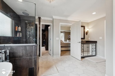 Discover luxurious lakefront living in this beautifully on Indianwood Golf and Country Club in Michigan - for sale on GolfHomes.com, golf home, golf lot