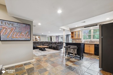 Discover luxurious lakefront living in this beautifully on Indianwood Golf and Country Club in Michigan - for sale on GolfHomes.com, golf home, golf lot