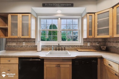 Discover luxurious lakefront living in this beautifully on Indianwood Golf and Country Club in Michigan - for sale on GolfHomes.com, golf home, golf lot