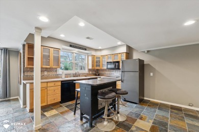 Discover luxurious lakefront living in this beautifully on Indianwood Golf and Country Club in Michigan - for sale on GolfHomes.com, golf home, golf lot