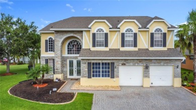 Stunning 5-Bedroom Pool Home on Expansive Corner Lot with Water on Oaks National Golf Course in Florida - for sale on GolfHomes.com, golf home, golf lot