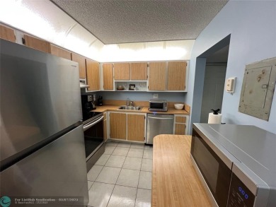 ALL AGES..E SEE IT RIGHT NOW...FIRST FLOOR END CORNER UNIT on Boca Dunes Golf and Country Club in Florida - for sale on GolfHomes.com, golf home, golf lot