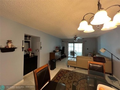 ALL AGES..E SEE IT RIGHT NOW...FIRST FLOOR END CORNER UNIT on Boca Dunes Golf and Country Club in Florida - for sale on GolfHomes.com, golf home, golf lot