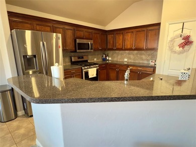 This very beautiful and well maintained 4-bedroom, 2-bath home on Eagle Mountain Country Club  in Texas - for sale on GolfHomes.com, golf home, golf lot