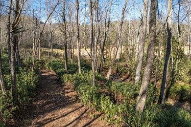 Nestled between the 5th green and the 6th tee, this 2.77-acre on Lake Toxaway Country Club in North Carolina - for sale on GolfHomes.com, golf home, golf lot
