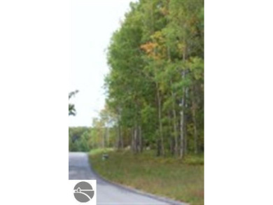 This beautiful building site is set on a hill overlooking the on A-Ga-Ming Golf Resort in Michigan - for sale on GolfHomes.com, golf home, golf lot