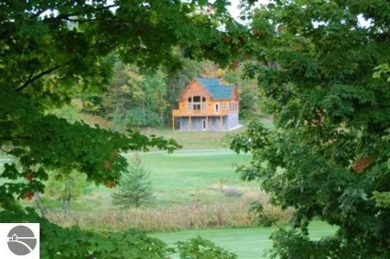 This beautiful building site is set on a hill overlooking the on A-Ga-Ming Golf Resort in Michigan - for sale on GolfHomes.com, golf home, golf lot