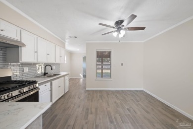 Discover an incredible opportunity to own a 4-bedroom brick home on Tiger Point Golf and Country Club in Florida - for sale on GolfHomes.com, golf home, golf lot