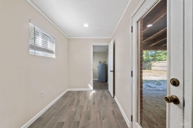 Discover an incredible opportunity to own a 4-bedroom brick home on Tiger Point Golf and Country Club in Florida - for sale on GolfHomes.com, golf home, golf lot