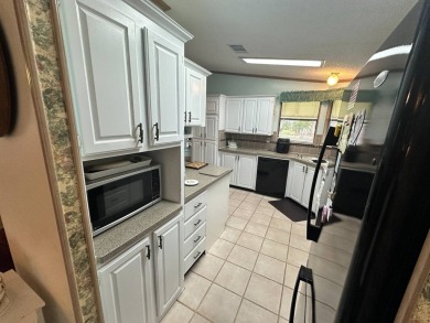 Beautiful stucco home on the exterior perimeter.  Updated on Del Tura Golf and Country Club in Florida - for sale on GolfHomes.com, golf home, golf lot