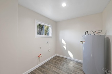 Discover an incredible opportunity to own a 4-bedroom brick home on Tiger Point Golf and Country Club in Florida - for sale on GolfHomes.com, golf home, golf lot