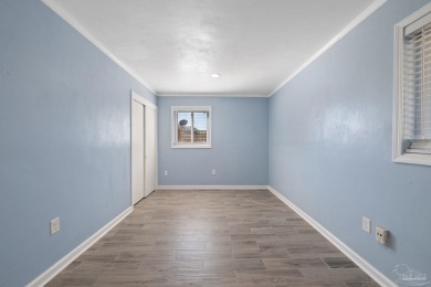 Discover an incredible opportunity to own a 4-bedroom brick home on Tiger Point Golf and Country Club in Florida - for sale on GolfHomes.com, golf home, golf lot