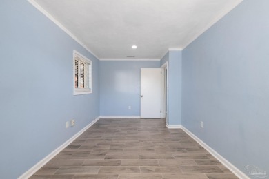 Discover an incredible opportunity to own a 4-bedroom brick home on Tiger Point Golf and Country Club in Florida - for sale on GolfHomes.com, golf home, golf lot
