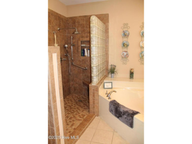 Welcome to your dream home! This custom-built residence is on Ocean Ridge Plantation in North Carolina - for sale on GolfHomes.com, golf home, golf lot