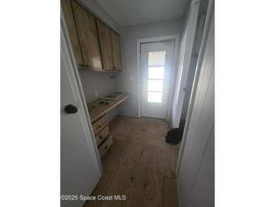 Partially renovated home is ready for handy owners or landlord on Barefoot Bay Golf Course in Florida - for sale on GolfHomes.com, golf home, golf lot