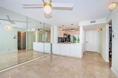 Find paradise in this one-of-a-kind lakefront villa in beautiful on Isla Del Sol Yacht and Country Club in Florida - for sale on GolfHomes.com, golf home, golf lot