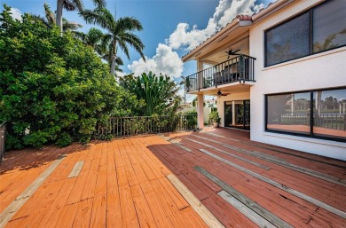 Find paradise in this one-of-a-kind lakefront villa in beautiful on Isla Del Sol Yacht and Country Club in Florida - for sale on GolfHomes.com, golf home, golf lot