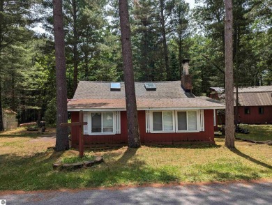 A cute two bedroom cottage sitting on a wide lot with sandy on Huron Breeze Golf Club in Michigan - for sale on GolfHomes.com, golf home, golf lot