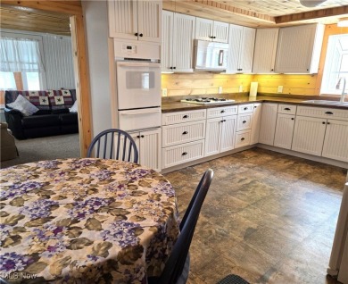 Welcome to this quaint, cape cod--nestled in a private Lake on The Harbor Golf Club in Ohio - for sale on GolfHomes.com, golf home, golf lot