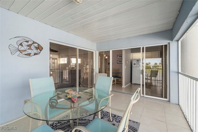 SUNLIGHT POURS IN OFF THE GLISTENING LAKE. Second floor end unit on Gulf Harbour Yacht and Country Club in Florida - for sale on GolfHomes.com, golf home, golf lot