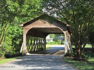 This .44 acre lot located on the golf course with trees in on Sound Golf Links at Albemarle Plantation in North Carolina - for sale on GolfHomes.com, golf home, golf lot