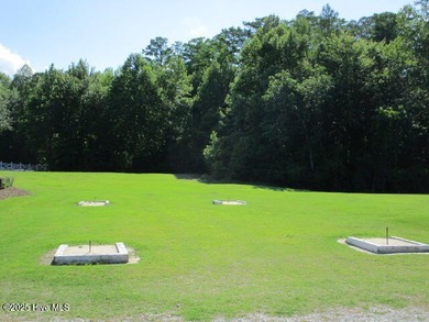 This .44 acre lot located on the golf course with trees in on Sound Golf Links at Albemarle Plantation in North Carolina - for sale on GolfHomes.com, golf home, golf lot