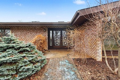 Situated on the prestigious Travis Pointe Golf Course on the on Travis Pointe Country Club in Michigan - for sale on GolfHomes.com, golf home, golf lot