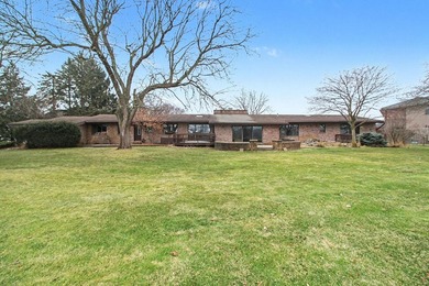 Situated on the prestigious Travis Pointe Golf Course on the on Travis Pointe Country Club in Michigan - for sale on GolfHomes.com, golf home, golf lot