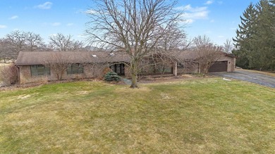 Situated on the prestigious Travis Pointe Golf Course on the on Travis Pointe Country Club in Michigan - for sale on GolfHomes.com, golf home, golf lot