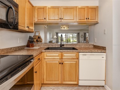 This first floor condo sits steps away from the community pool on Plantation Golf and Country Club in Florida - for sale on GolfHomes.com, golf home, golf lot