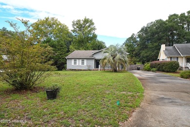 Some homes are unassuming from the outside and absolutely on Sea Trail Golf Resort in North Carolina - for sale on GolfHomes.com, golf home, golf lot