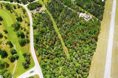 Discover 1.7 acres of beautifully wooded land, conveniently on Lakes of the North Deer Run Golf Course in Michigan - for sale on GolfHomes.com, golf home, golf lot