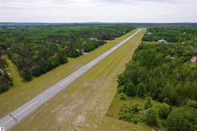 Discover 1.7 acres of beautifully wooded land, conveniently on Lakes of the North Deer Run Golf Course in Michigan - for sale on GolfHomes.com, golf home, golf lot