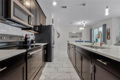 Escape to sun-drenched luxury at 1566 Plunker Drive, a stunning on The Oasis Club at Champions Gate in Florida - for sale on GolfHomes.com, golf home, golf lot