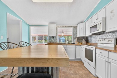 Come home to your beach getaway. This two bedroom, two flex on Oyster Bay Golf Links in North Carolina - for sale on GolfHomes.com, golf home, golf lot