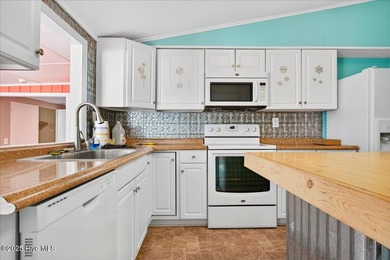 Come home to your beach getaway. This two bedroom, two flex on Oyster Bay Golf Links in North Carolina - for sale on GolfHomes.com, golf home, golf lot