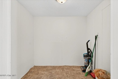 Come home to your beach getaway. This two bedroom, two flex on Oyster Bay Golf Links in North Carolina - for sale on GolfHomes.com, golf home, golf lot