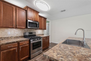 Welcome to this meticulously maintained 4-bedroom, 2-bath on Grand Reserve Golf Course in Florida - for sale on GolfHomes.com, golf home, golf lot