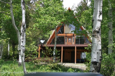 Quaint A-frame cabin nestled in the trees with fabulous views of on Aspen Hills Golf Course in Wyoming - for sale on GolfHomes.com, golf home, golf lot