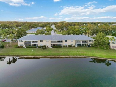 Enjoy peaceful unobstructed views of the lake and golf course on Palm Aire Country Club of Sarasota in Florida - for sale on GolfHomes.com, golf home, golf lot