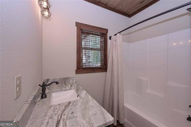 Nestled in the serene beauty of the North Georgia mountains on White Path Golf Club in Georgia - for sale on GolfHomes.com, golf home, golf lot