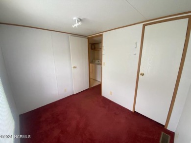 This 2 bedrooms, 1 bath manufactured home sits on a corner lot on Chowan Golf and Country Club in North Carolina - for sale on GolfHomes.com, golf home, golf lot
