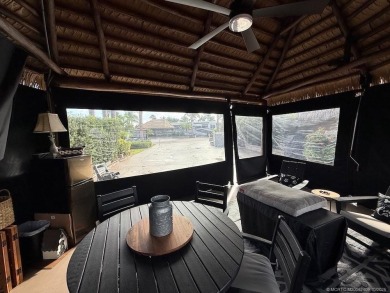 This beautifully landscaped tiki lot offers breathtaking sunset on Motorcoach Resort Golf Course in Florida - for sale on GolfHomes.com, golf home, golf lot