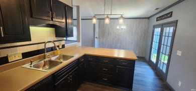 Enjoy the beautiful open views from this 3 bedroom, one and a on Coyote Creek Golf Club in Indiana - for sale on GolfHomes.com, golf home, golf lot