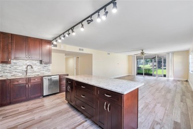 Beautifully renovated 3-bedroom, 2-bathroom corner unit in Holly on Woodmont Country Club in Florida - for sale on GolfHomes.com, golf home, golf lot